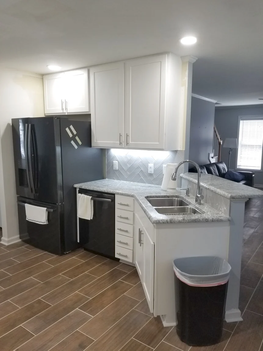 Kitchen remodel with new cabinetry, counters, and lighting