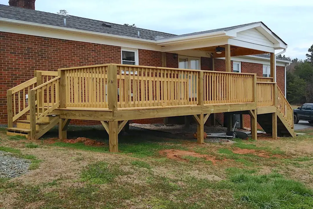 The same home after a complete deck rebuild with new framing, stairs, and railings