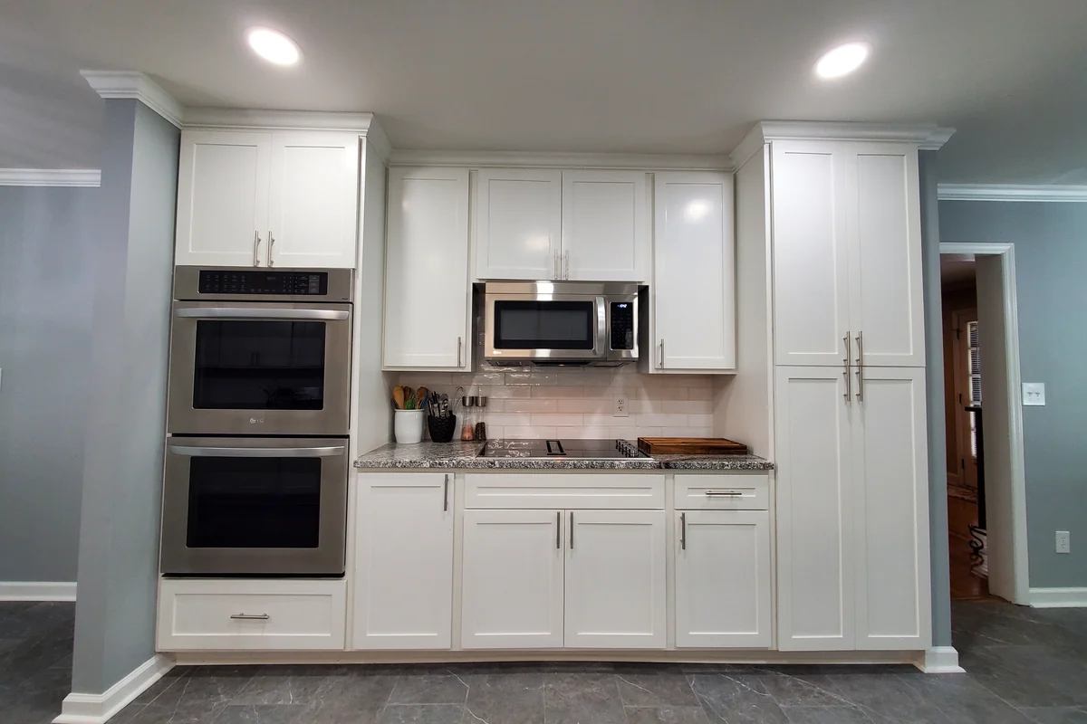 The same kitchen after remodeling with new cabinetry, counters, and appliances