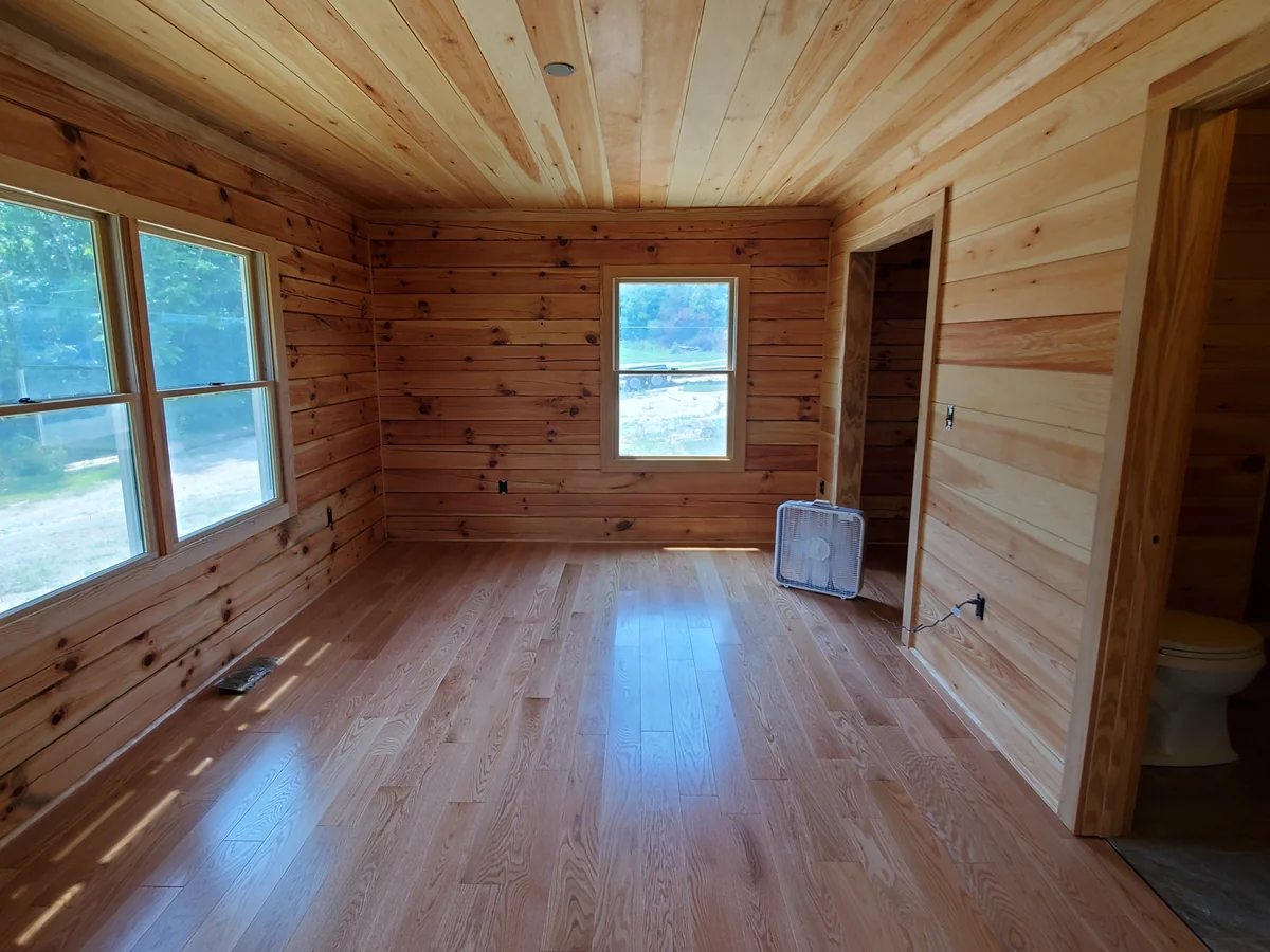 Custom home interior with pine walls and hardwood flooring