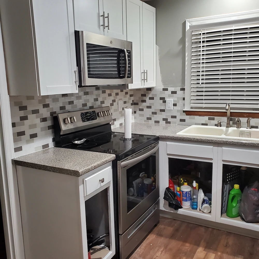 Kitchen remodel with a tile backsplash and updated appliances