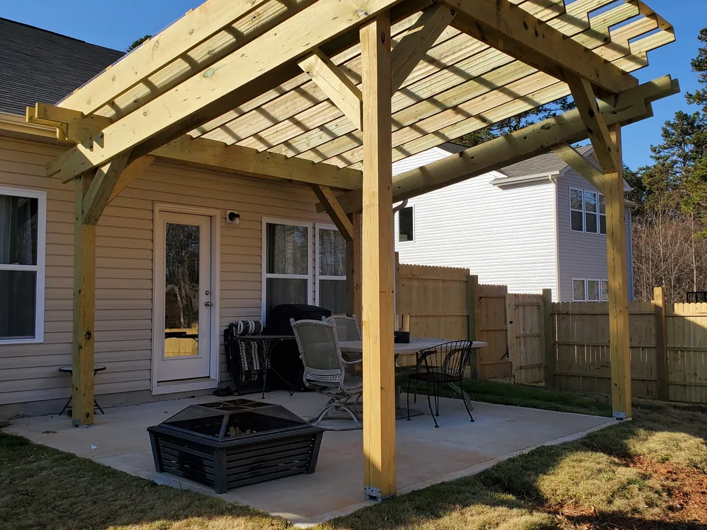 Custom pergola over a patio with a fire pit