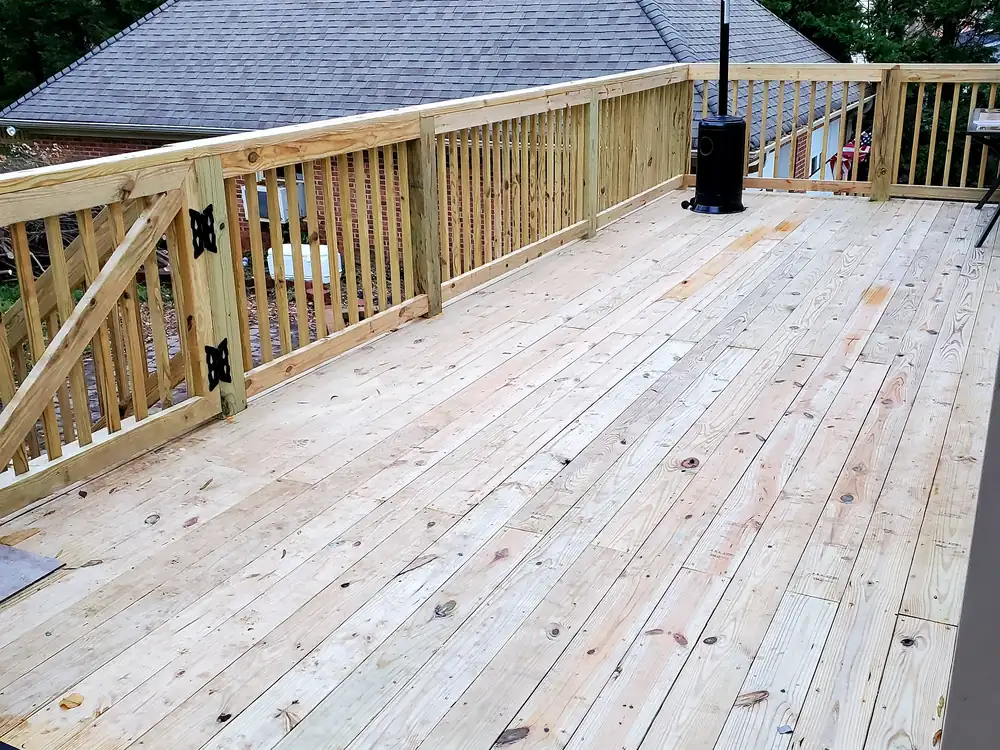Rebuilt deck with fresh boards and new wood railings