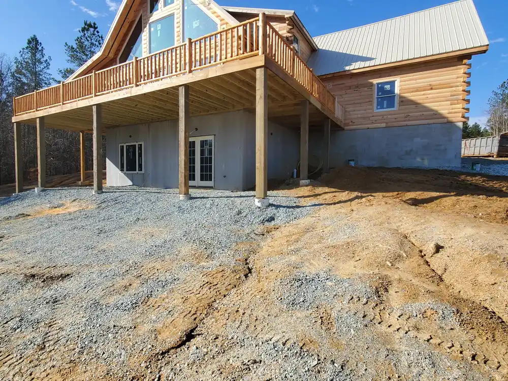 Custom log home exterior with a full-length deck