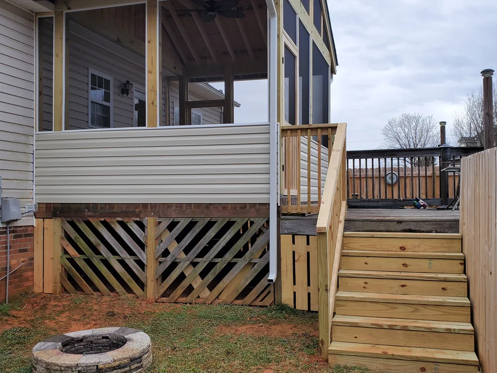 Deck and screened porch with a backyard fire pit
