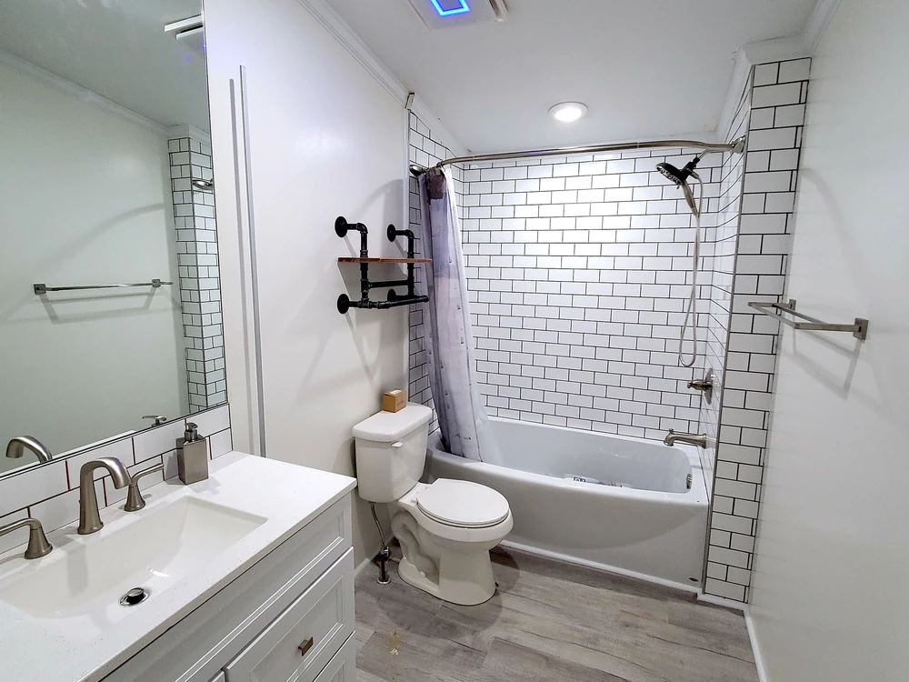Bathroom remodel with a new vanity and tiled tub surround
