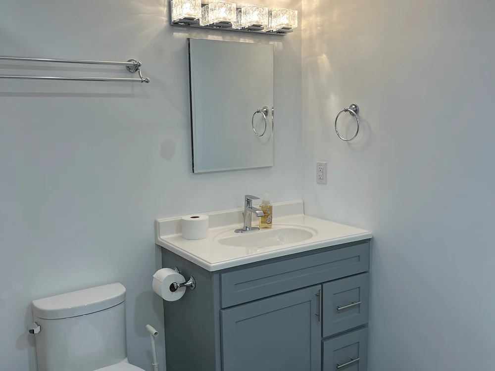 New bathroom vanity, mirror, and lighting